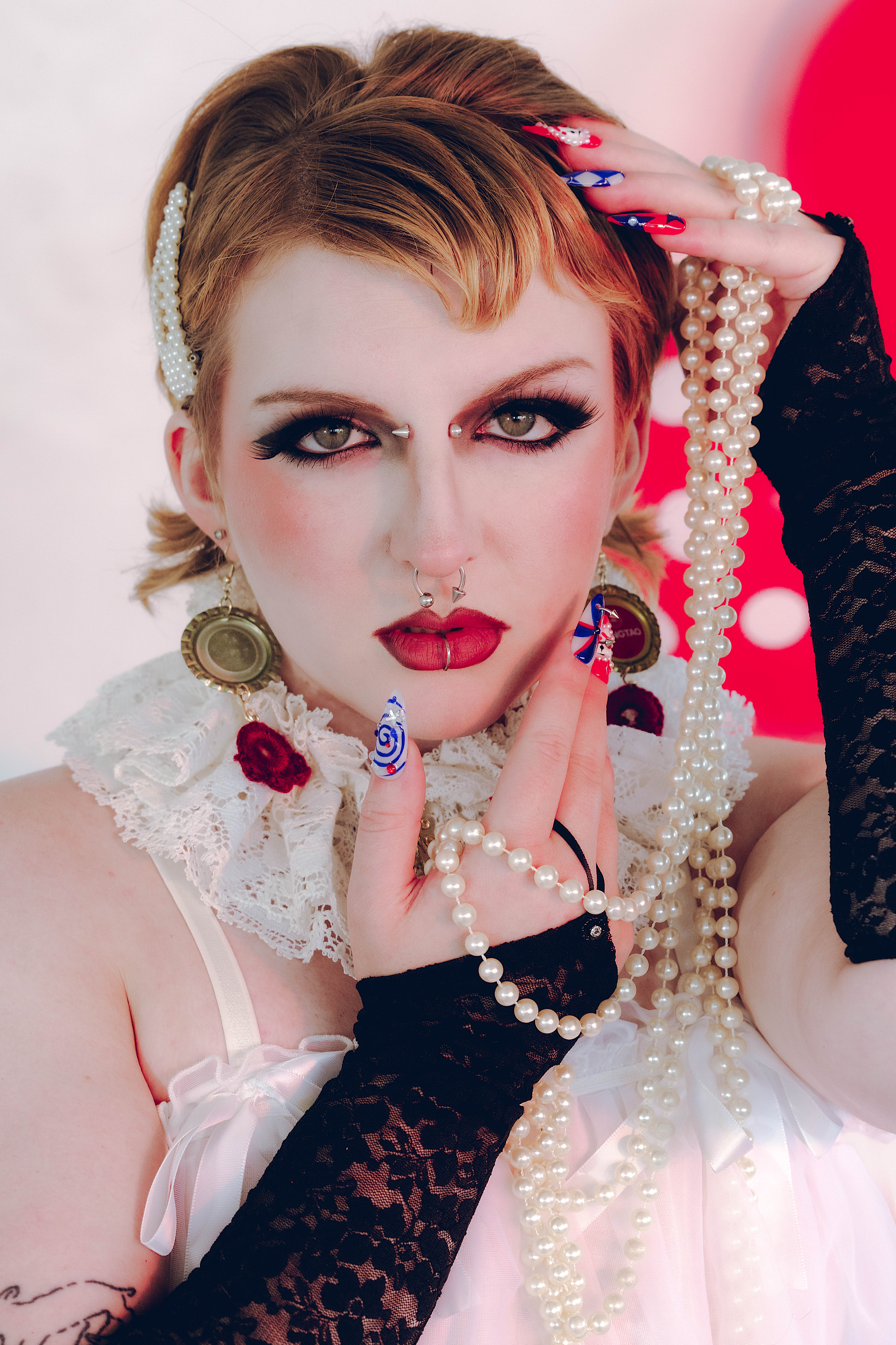 NYX Tamère applies makeup while in a sequined costume